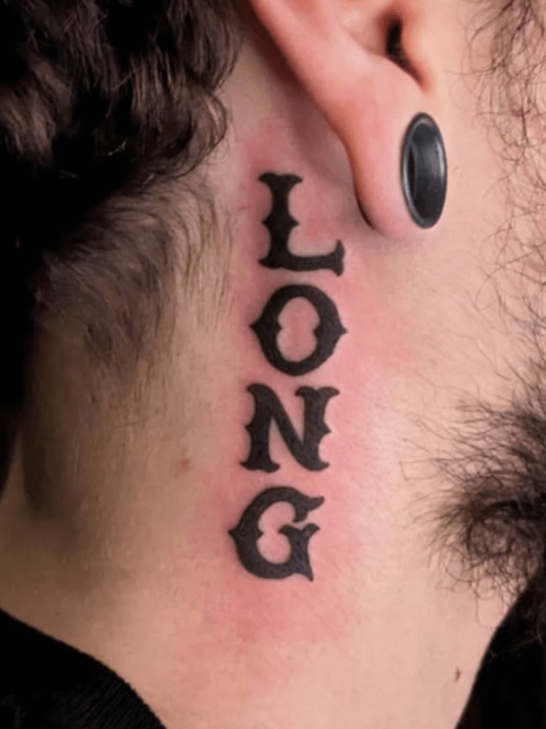 Clean tattoo of lettering on someone's neck.